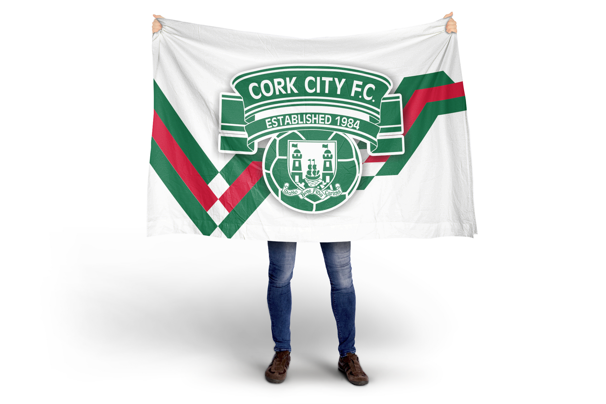 Cork City F.C. Diagonal Stripe Flag with modern crest in red, white and green being held up.