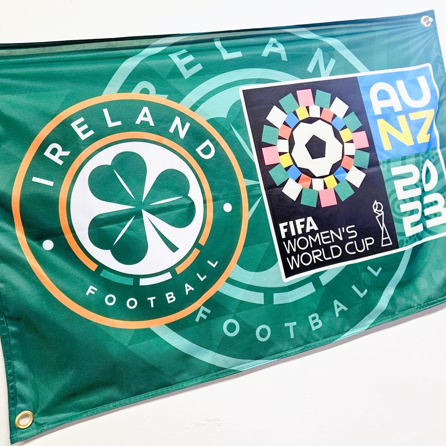 Flag with Ireland Football logo and FIFA Women's World Cup 2023 logo on a green background