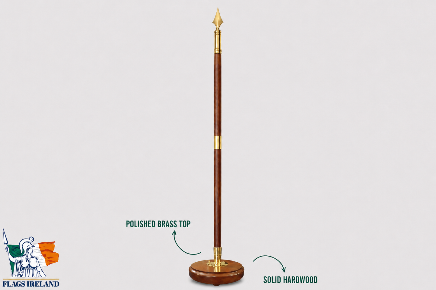 A polished hardwood flagpole with a polished brass top and base, shown on a light gray background with text callouts reading 'POLISHED BRASS TOP' and 'SOLID HARDWOOD'. A 'FLAGS IRELAND' logo appears in the bottom-left corner.
