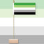 Flag with green, gray, and black stripes on a stand against a gradient background. Aromantic Pride Flag.
