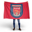 Person holding an Arsenal flag with the club's emblem on a white background