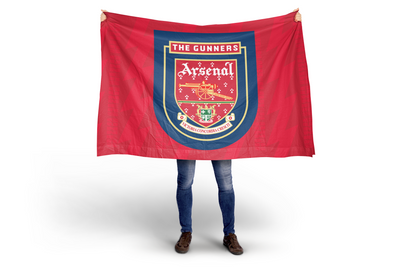Person holding an Arsenal flag with the club's emblem on a white background