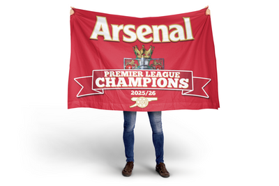 Person holding a red Arsenal flag with 'Premier League Champions 2025/26' text on a white background