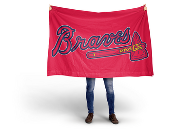 Person holding a red Atlanta Braves flag on a white background