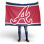Person holding a large red flag with a white 'A' logo on a white background