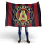 Person holding a Atlanta United FC flag on a white background