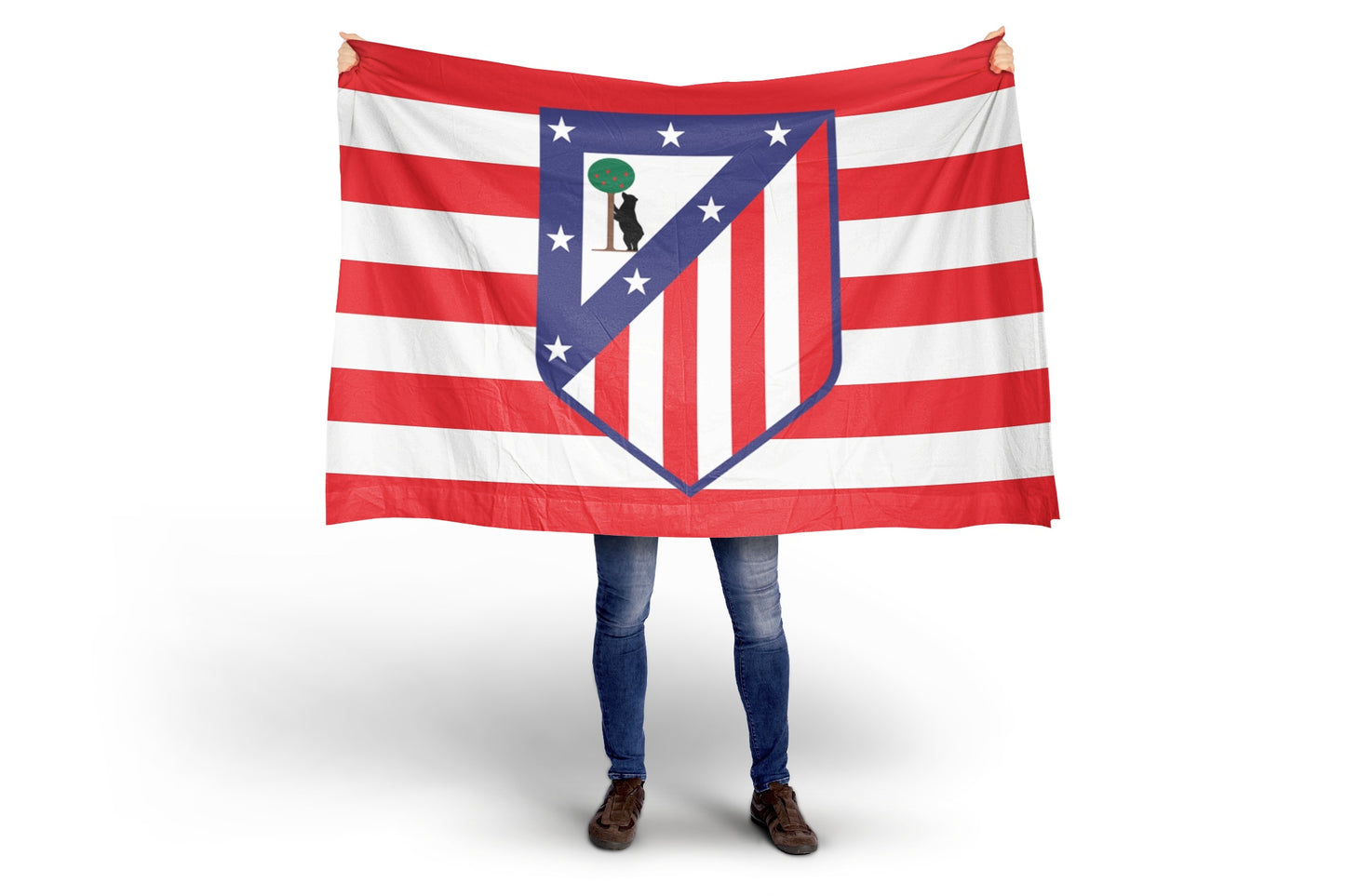 Person holding a large flag with atletico de madrid crest on a white background