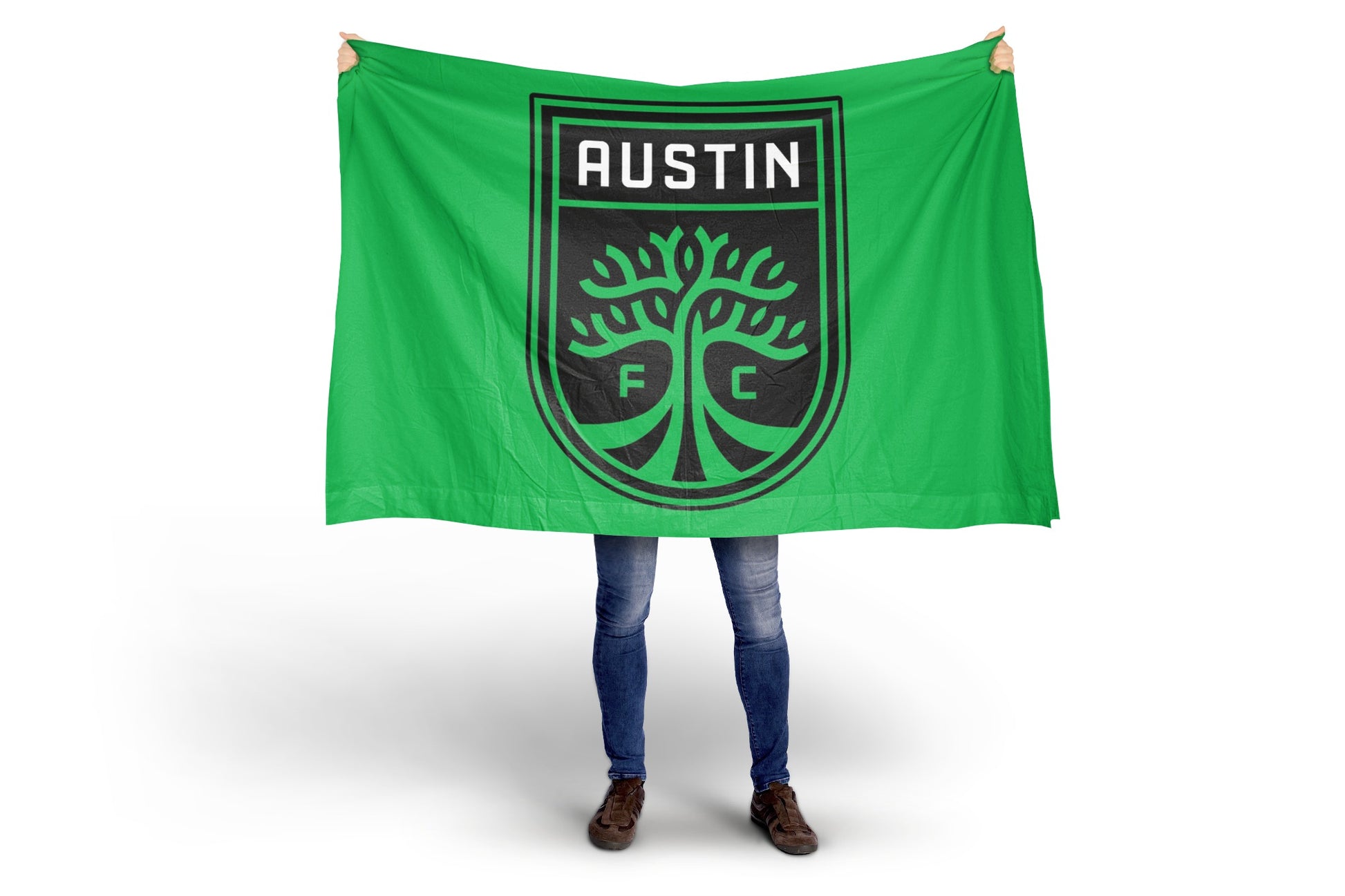 Person holding a green flag with 'Austin FC' logo on a white background