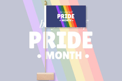 Pride month flag with rainbow design and text on a light gray background. Be Yourself Pride Month
