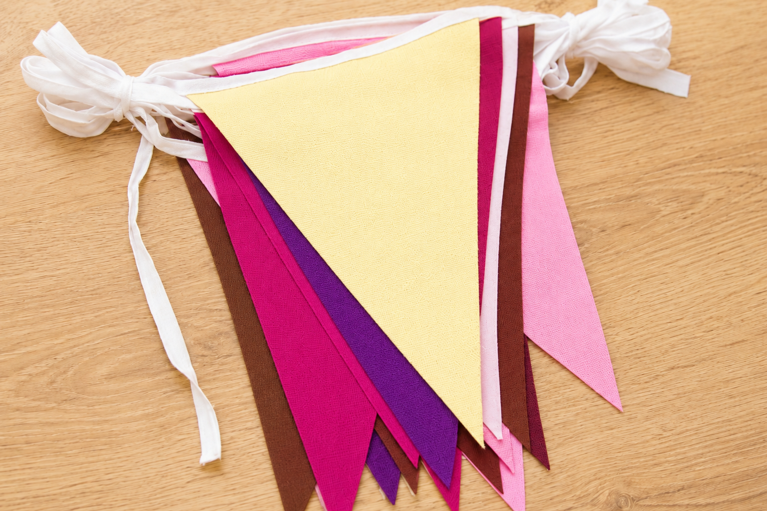 Color swatch of berry and cocoa triangle bunting with cream, hot pink, purple, marron, baby pink and brown colours.