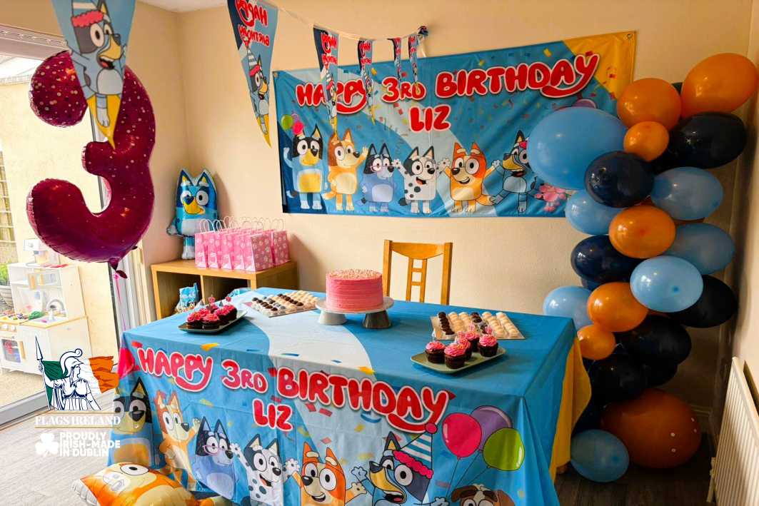 Children's birthday party setup with a 'Happy 3rd Birthday Liz' banner and decorations.
