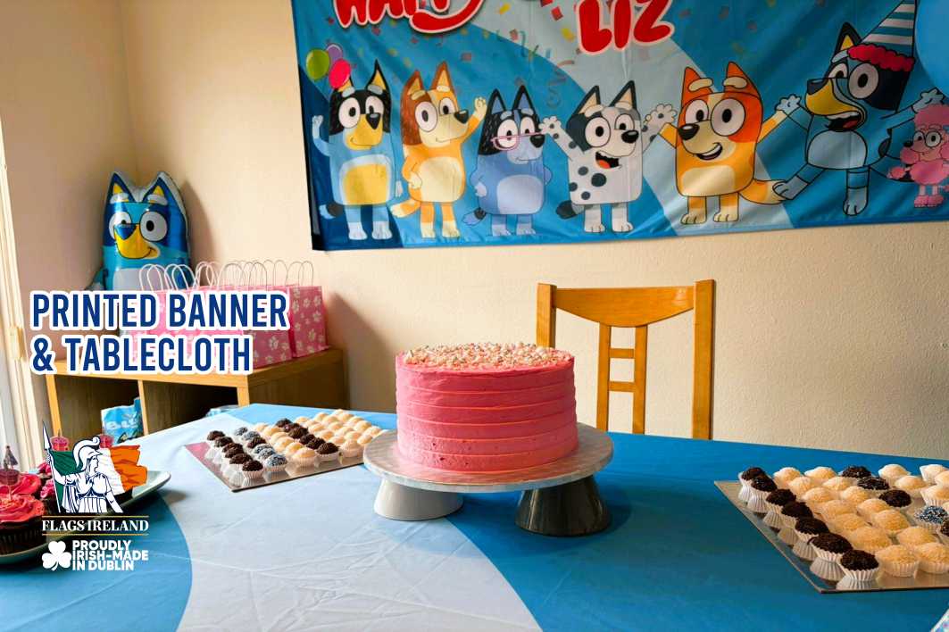 Birthday party setup with a pink cake, cupcakes, and a Bluey-themed banner on a table.