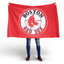 Person holding a Boston Red Sox flag on a white background