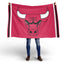 Person holding a large red flag with a bull logo on a white background