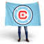 Person holding a Chicago FB blue flag with a red and white logo on a white background