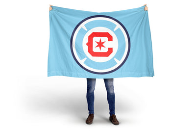 Person holding a Chicago FB blue flag with a red and white logo on a white background