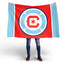 Person holding a Chicago FC red and blue flag with a logo on a white background