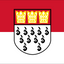 Cologne Flag. A red and white horizontal bicolor flag with a central shield containing three gold crowns on the upper half and black heraldic marks on the lower half.