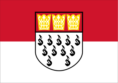 Cologne Flag. A red and white horizontal bicolor flag with a central shield containing three gold crowns on the upper half and black heraldic marks on the lower half.