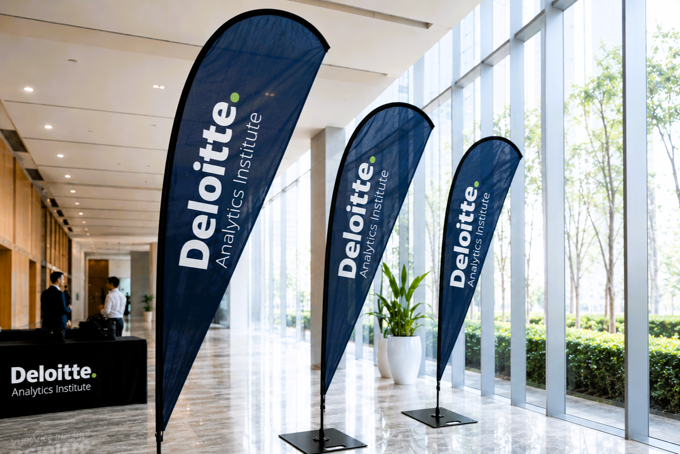 Deloitte Analytics Institute banners in a modern indoor setting with large windows.