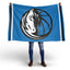 Person holding a Dallas Mavericks blue flag with a logo on a white background