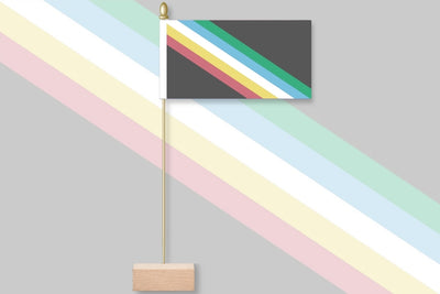 Colorful striped flag with a wooden base on a gray background. Disability Pride - Updated Version