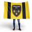 Person holding a Dragons RFC flag with a black and yellow design.