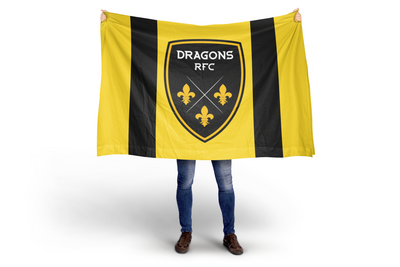 Person holding a Dragons RFC flag with a black and yellow design.