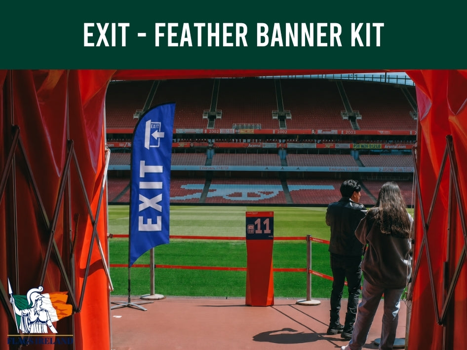 Blue 'EXIT' feather banner at a sports stadium with people taking a photo.