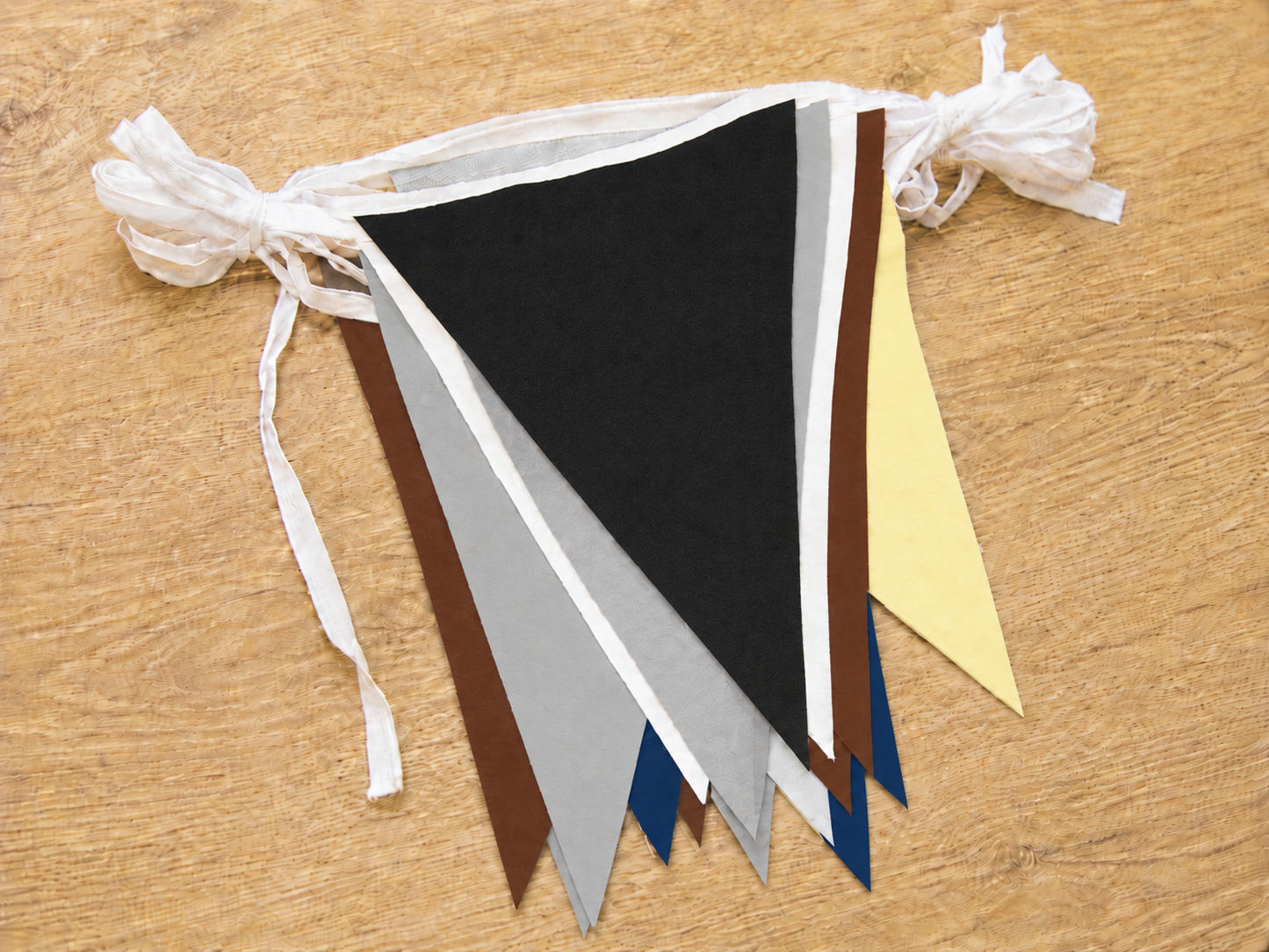 Colorful polyester triangle bunting flags on a wooden surface