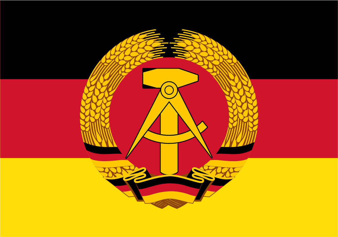East Germany GDR Flag. The flag of the German Democratic Republic (GDR) is shown, featuring horizontal stripes of black, red, and yellow, with a central emblem of a golden hammer and sickle enclosed in a wreath of wheat.