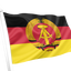East Germany GDR Flag. A flag on a white pole, featuring horizontal black, red, and yellow bands with a central emblem of a golden wheat sheaf and compass inside a red circle, isolated on a white background. 