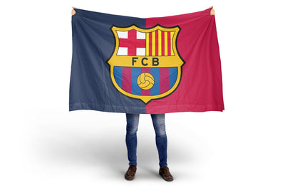 Person holding a Barcelona flag with the club's logo on a white background