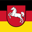 German Lower Saxony flag design with horizontal black, red, and yellow bands and a red shield containing a white horse emblem centered on the flag.