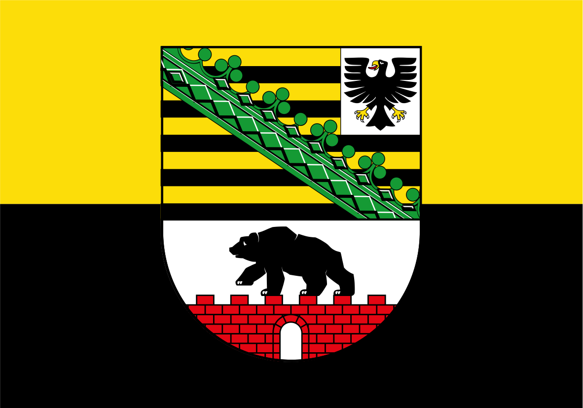 Saxony Anhalt Province Flag. The flag of Bamberg, Germany, featuring a horizontal bicolor design of yellow on top and black on the bottom, with a central coat of arms containing a green trellis, black-and-yellow stripes, a white eagle, a black bear, and a red brick wall.
