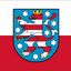 Thuringia State Flag red and white horizontal bicolor flag with a central heraldic shield showing a red lion rampant on a blue field with white stars and a gold crown.