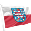Thuringia State flag on a white pole featuring a horizontal white upper band and red lower band, with a central blue shield containing a red and blue heraldic lion and white stars.