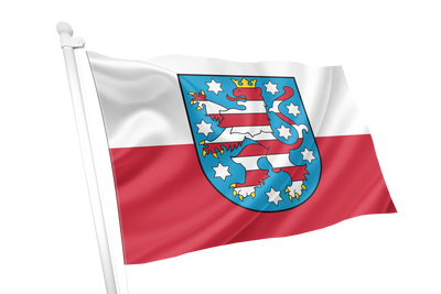 Thuringia State flag on a white pole featuring a horizontal white upper band and red lower band, with a central blue shield containing a red and blue heraldic lion and white stars.