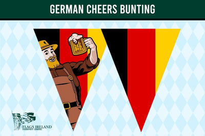A triangular pennant banner design featuring the German flag colors with a cartoon beer-bowling figure on a light blue harlequin patterned background. A dark green banner at the top reads 'GERMAN CHEERS BUNTING' and a small 'Flags Ireland' logo appears in the lower left.