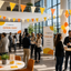 Open Day event with people networking in a modern building with bunting decoration.