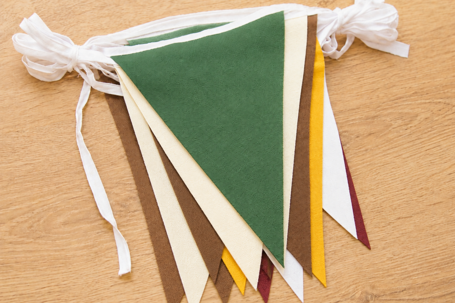 Color swatch for Heritage Fair Bunting with green, cream, brown, golden yellow, white, and maroon bunting flags 