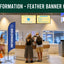 Feather banner with 'Information' text in an indoor setting, possibly an airport or information desk.