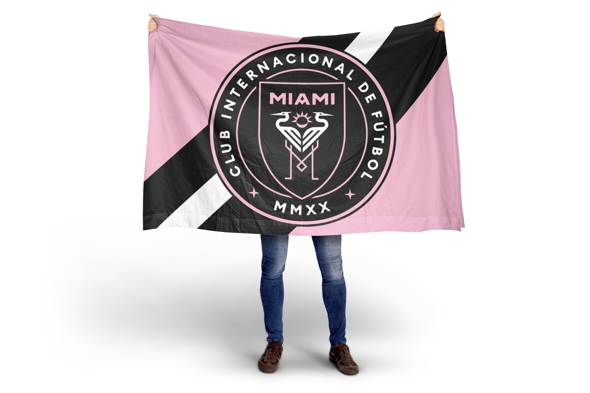 Person holding a flag with Club Internacional Inter Miami FC logo on a white background