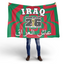 Person holding a large Iraq World Cup 2026 flag with red and green design.