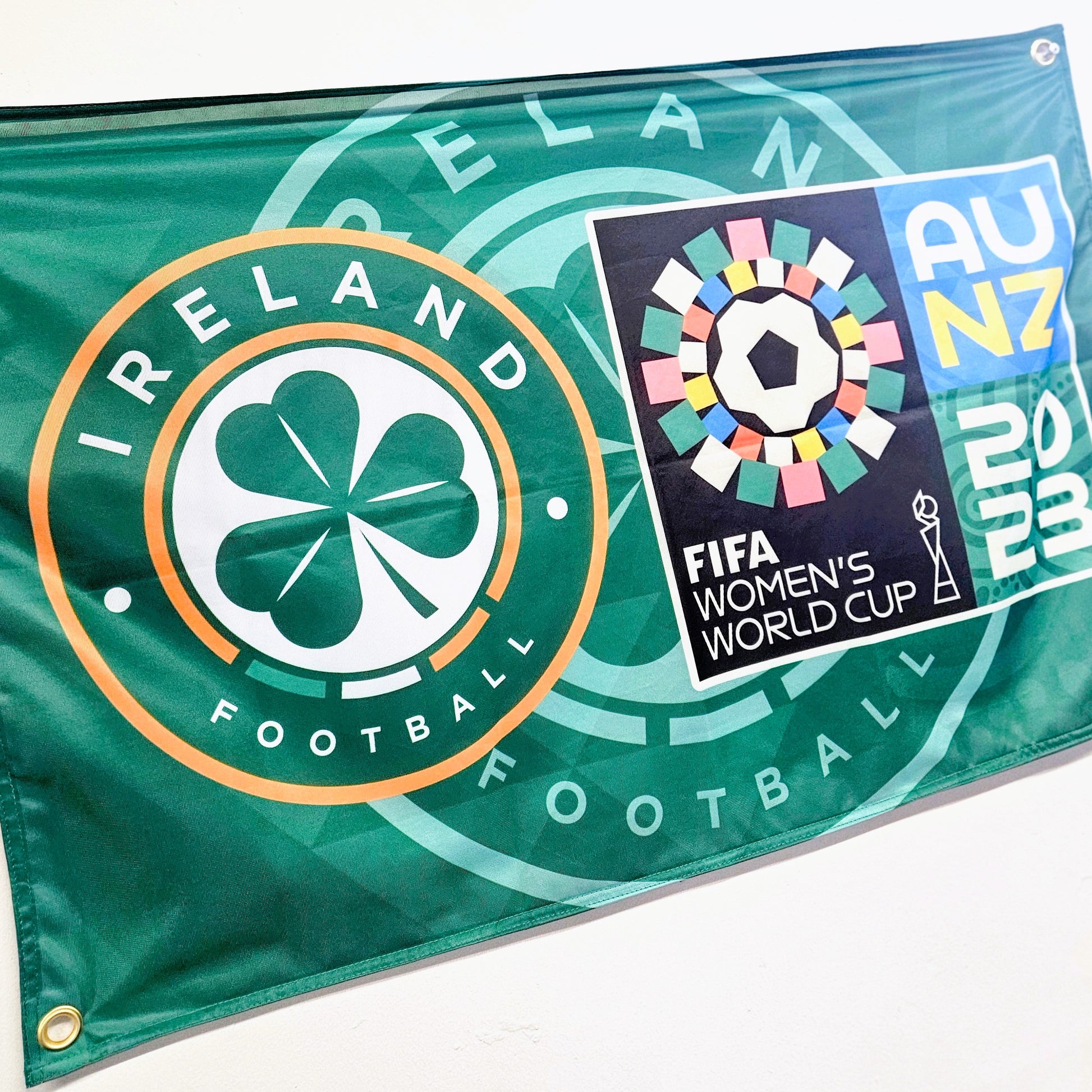 Flag with Ireland Football logo and FIFA Women's World Cup 2023 logo on a green background