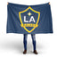 Person holding a LA Galaxy flag on a white background
