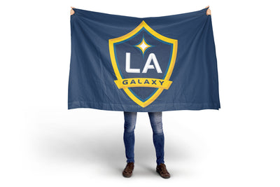 Person holding a LA Galaxy flag on a white background