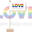 Pride-themed decoration with rainbow colors and 'LOVE' text on a white background. LOVE - Happy Pride Month