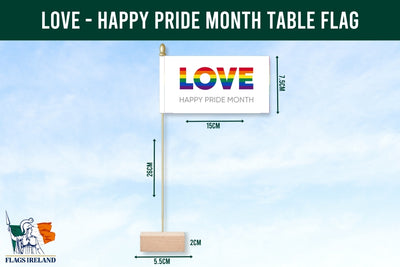 Table flag with 'LOVE' and 'Happy Pride Month' text, displayed with measurements against a blue sky background.