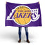 Person holding a Los Angeles Lakers flag on a white background
